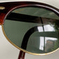 Sunglasses with dark lenses and wooden frame on a white background