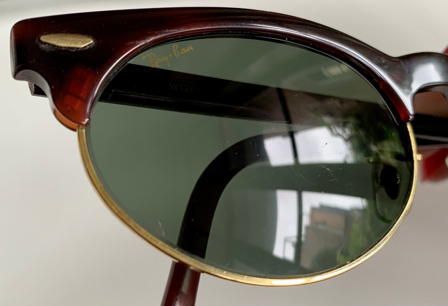Sunglasses with dark lenses and wooden frame on a white background