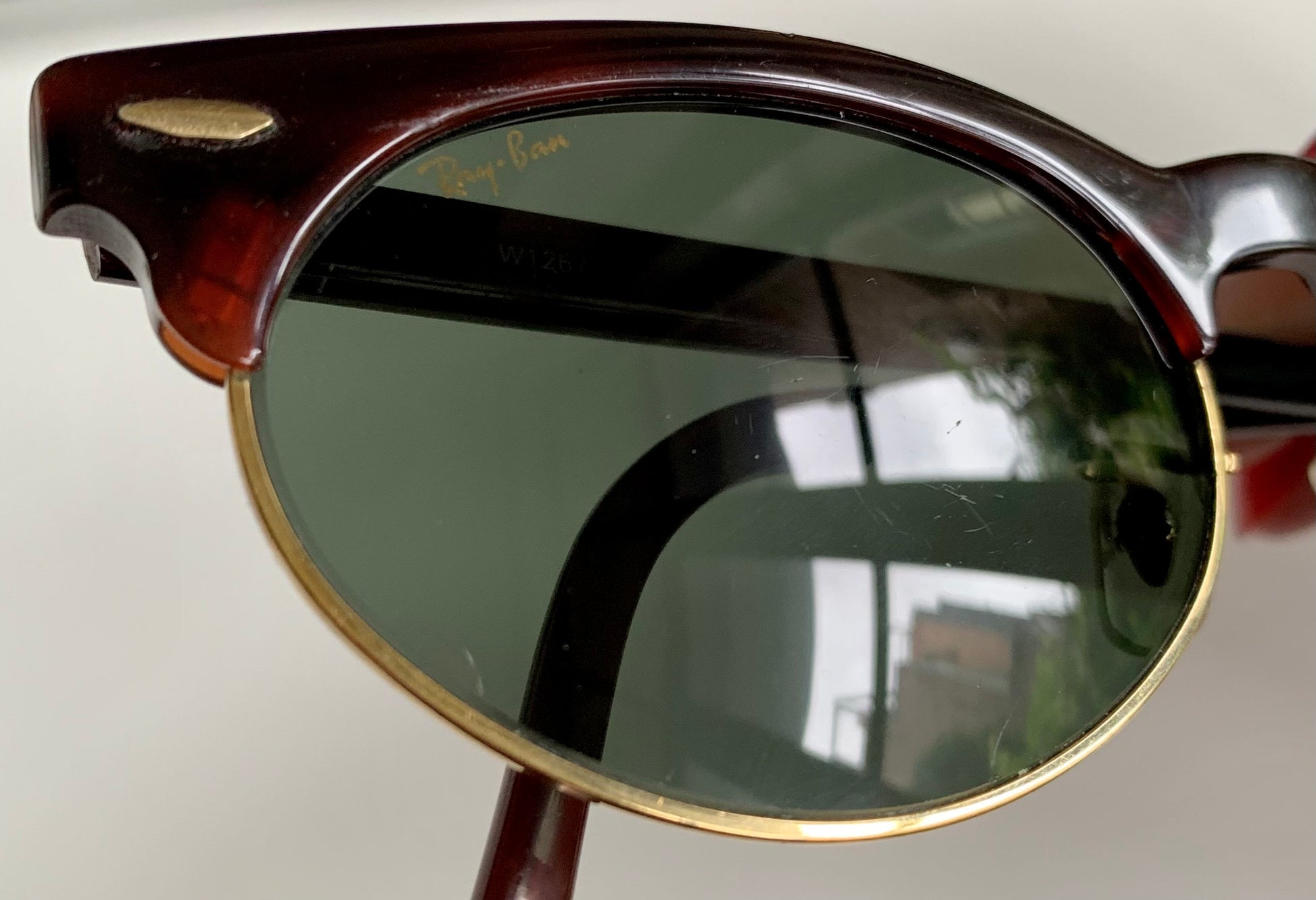 Sunglasses with dark lenses and wooden frame on a white background