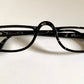 Christian Dior black eyeglasses on a white background