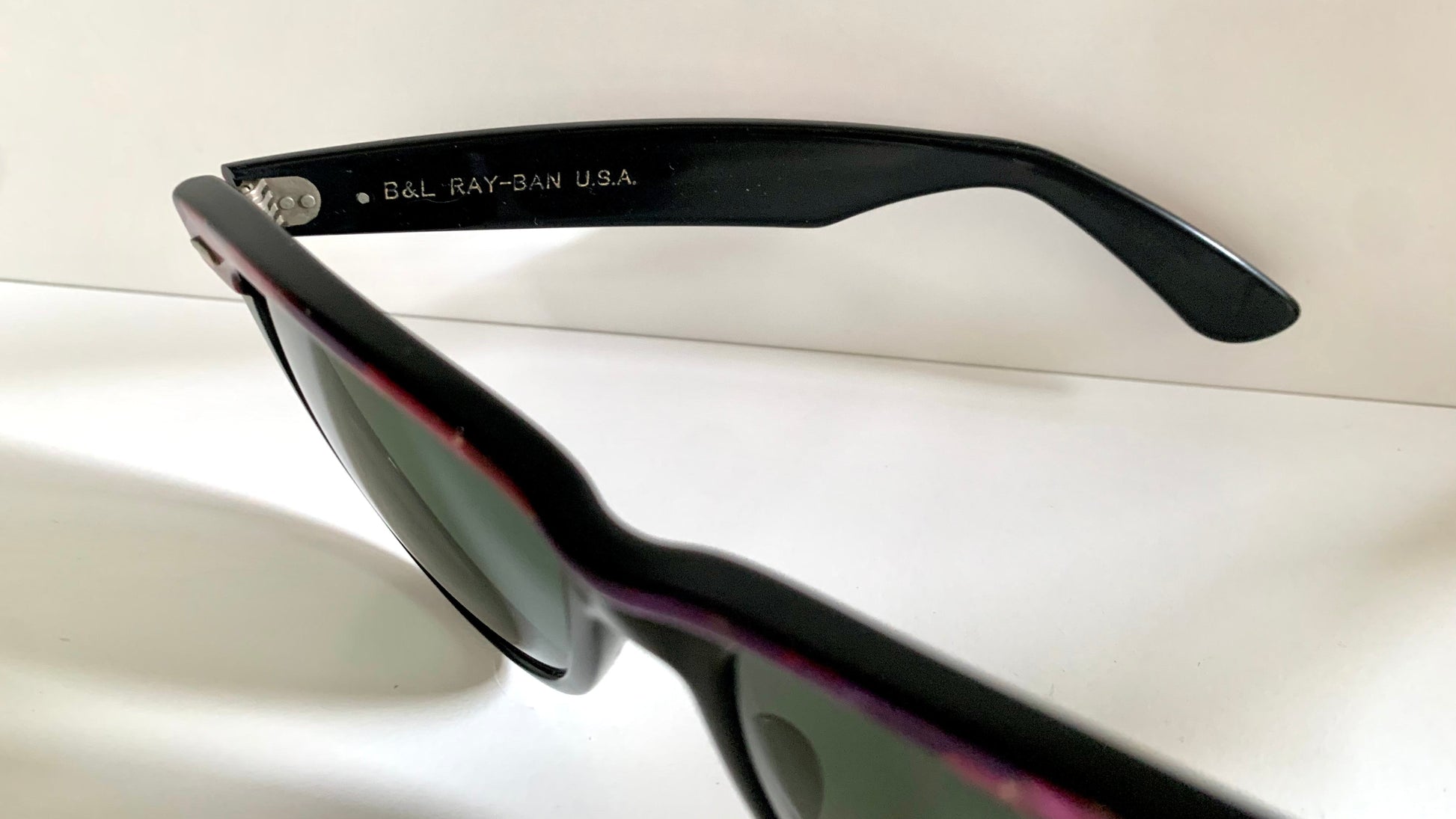 Ray Ban Sreet neat sunglasses with pink mosaice frame on a white surface