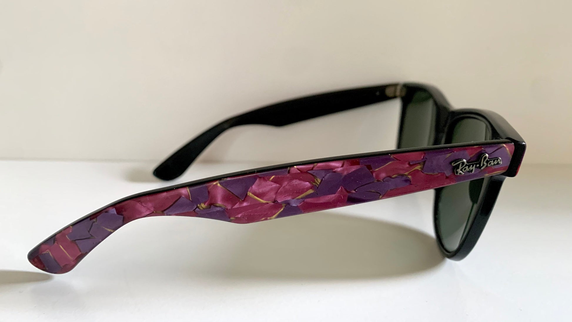 Ray Ban Sreet neat sunglasses with pink mosaice frame on a white surface