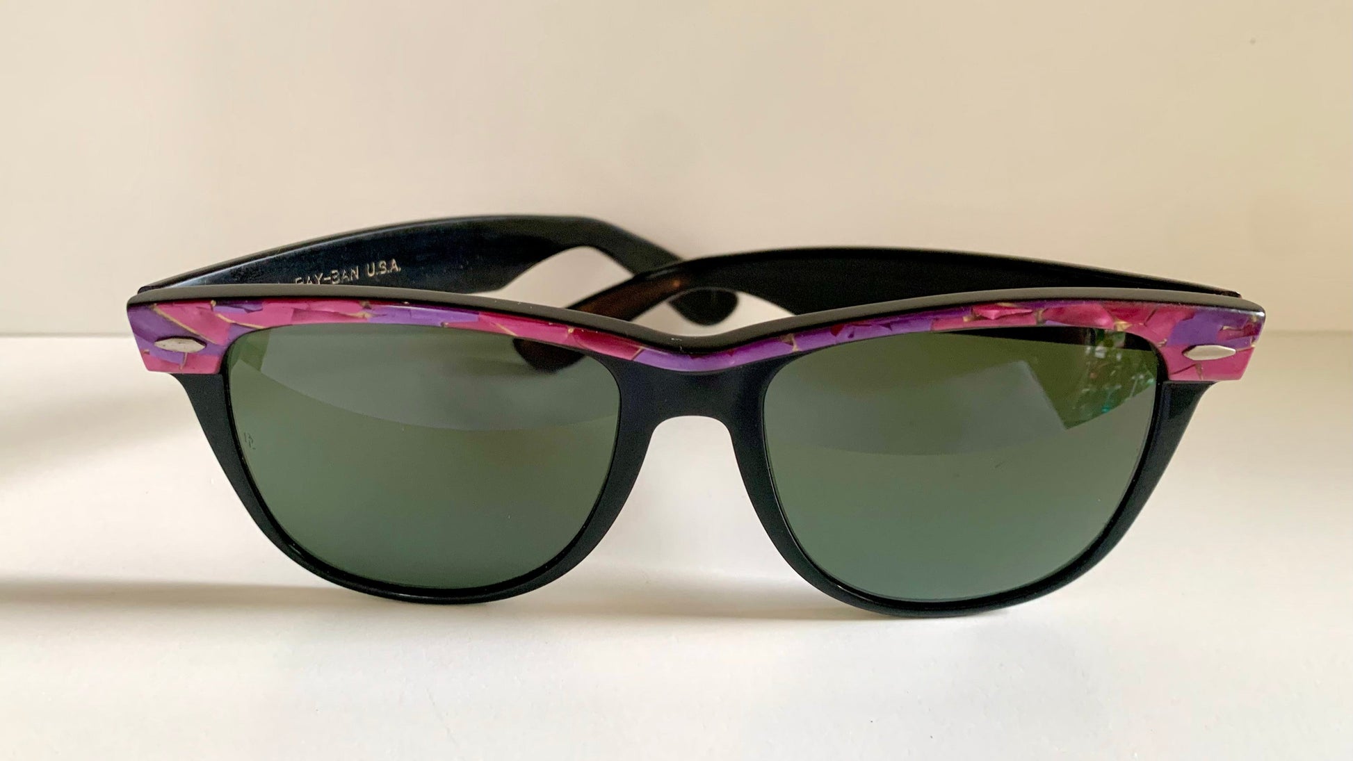 Ray Ban Sreet neat sunglasses with pink mosaice frame on a white surface