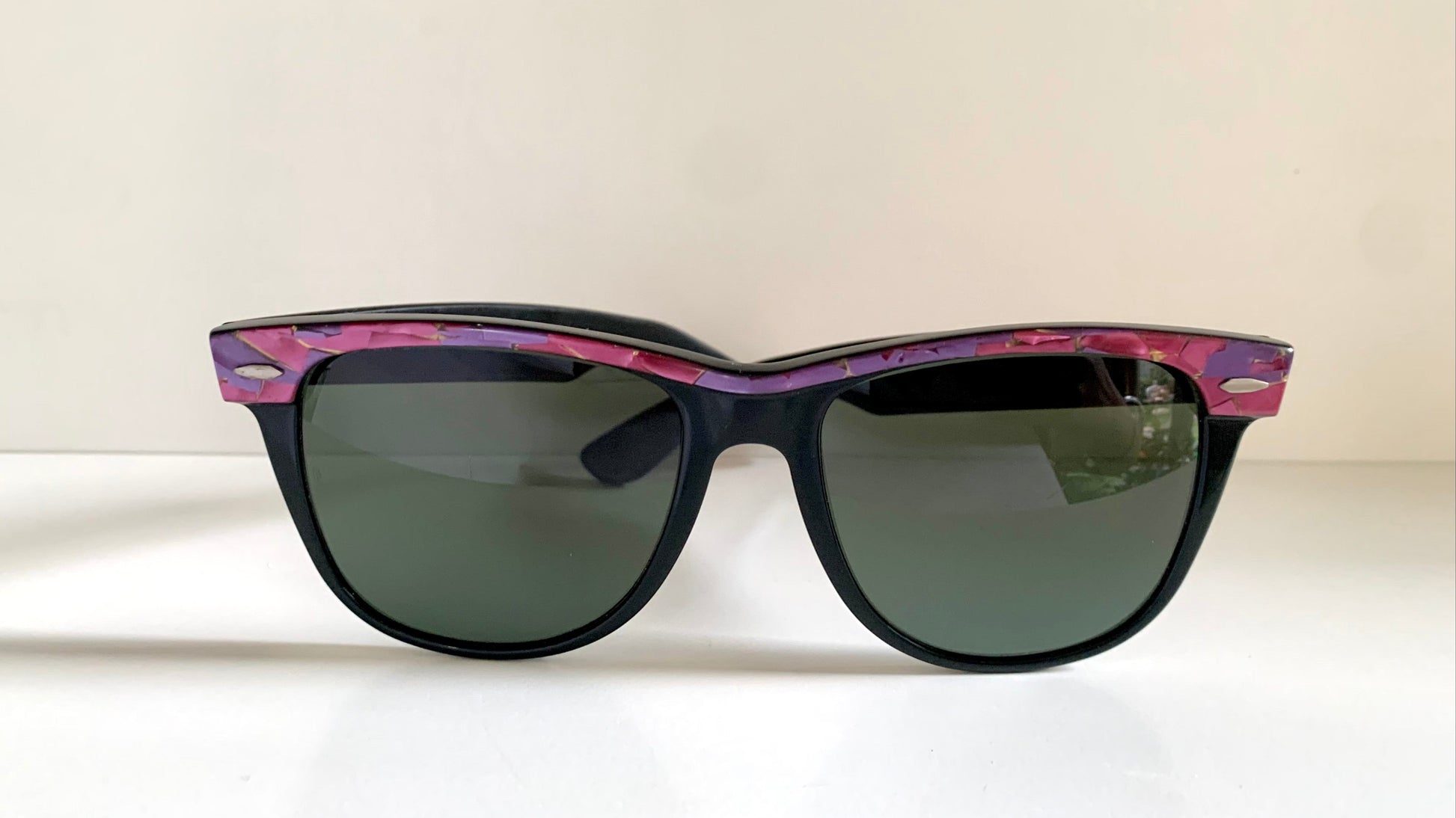 Ray Ban Sreet neat sunglasses with pink mosaice frame on a white surface