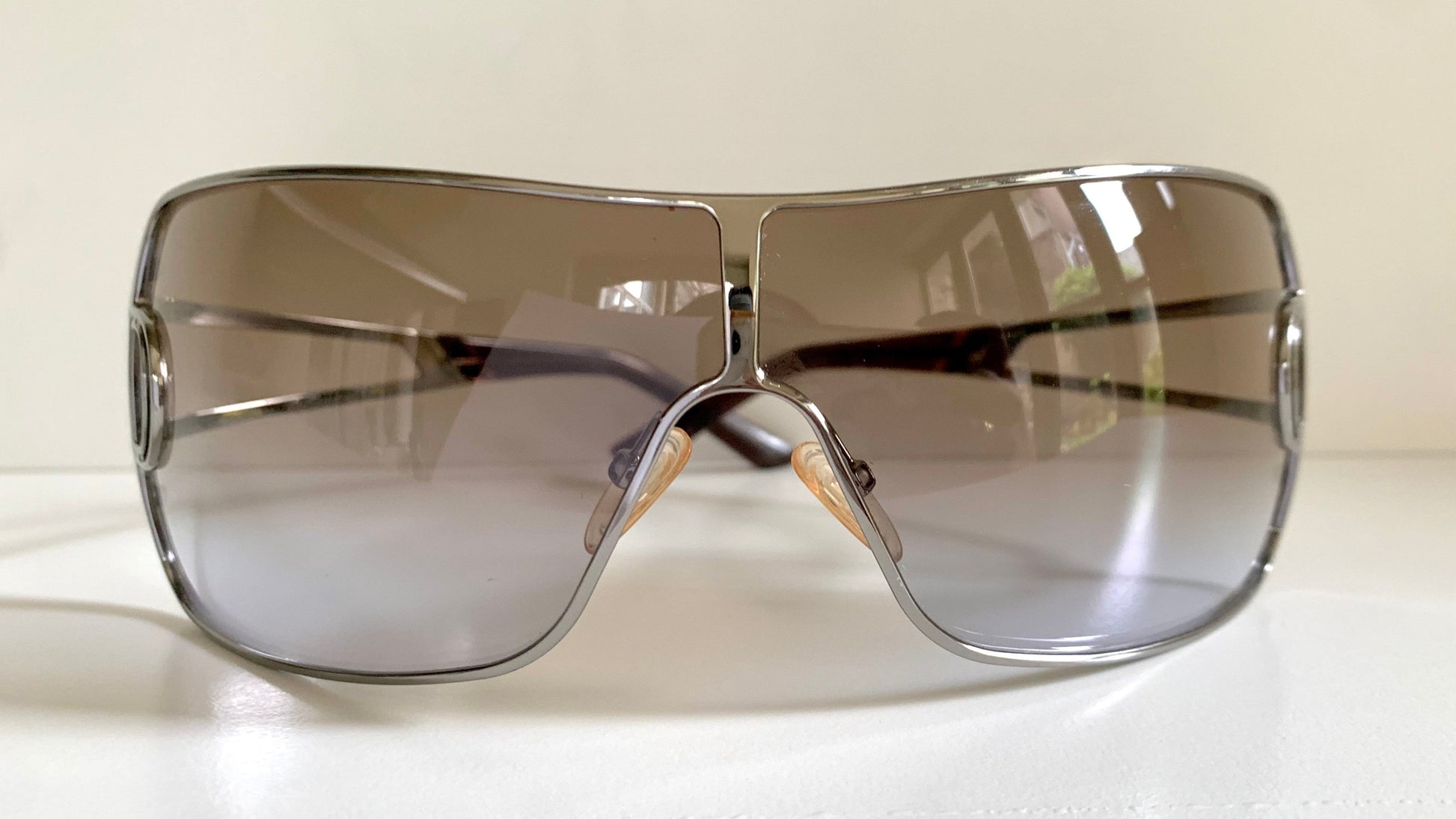 Christian Dior Diorissimo shield sunglasses on a white background