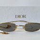 Gold-framed sunglasses with 'Dior' branding on a white background