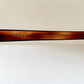 Brown sunglasses with tortoiseshell pattern on a beige background
