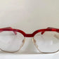 Red eyeglasses with a visible brand logo on a white background