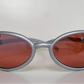 Lacoste silver-framed sunglasses with pink lenses on a white background