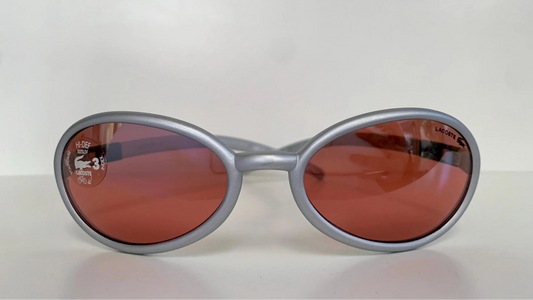 Lacoste silver-framed sunglasses with pink lenses on a white background